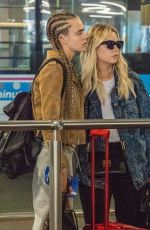 CARA DELEVINGNE and ASHLEY BENSON at Heathrow Airport in London 08/13/2018