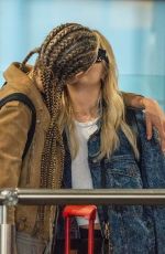 CARA DELEVINGNE and ASHLEY BENSON at Heathrow Airport in London 08/13/2018