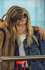 CARA DELEVINGNE and ASHLEY BENSON at Heathrow Airport in London 08/13/2018