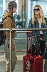 CARA DELEVINGNE and ASHLEY BENSON at Heathrow Airport in London 08/13/2018