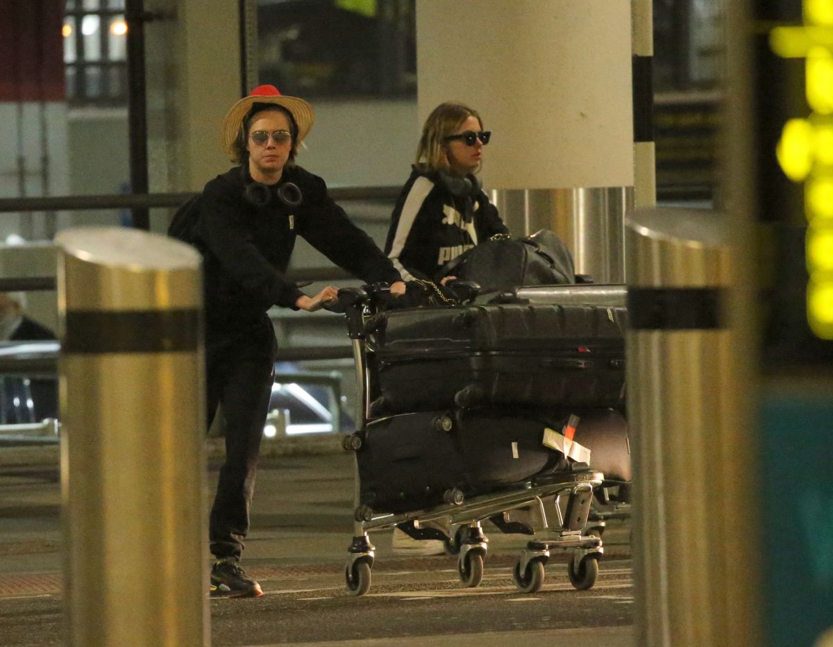 ASHLEY BENSON and CARA DELEVINGNE at Gatwick Airport in London 12/21 ...