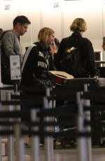 ASHLEY BENSON and CARA DELEVINGNE at Gatwick Airport in London 12/21/2018