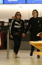 ASHLEY BENSON and CARA DELEVINGNE at Gatwick Airport in London 12/21/2018
