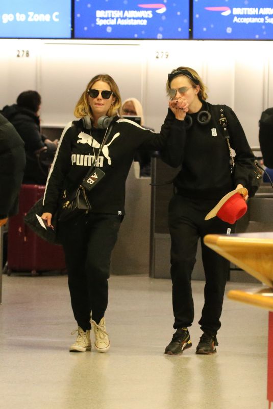 ASHLEY BENSON and CARA DELEVINGNE at Gatwick Airport in London 12/21/2018