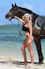 MEGAN BARTON HANSON in Bikini Riding a Horse at a Beach in Mauritius 12/23/2018