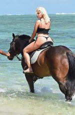 MEGAN BARTON HANSON in Bikini Riding a Horse at a Beach in Mauritius 12/23/2018