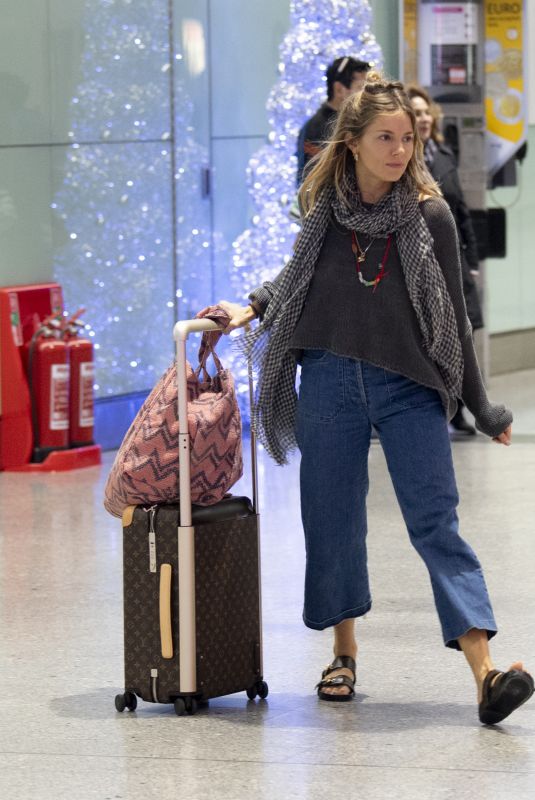 SIENNA MILLER at Heathrow Airport in London 12/27/2018