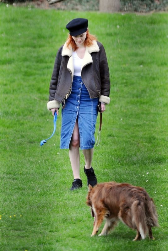 ELEANOR TOMLINSON with Her Dog at a Park in London 03/29/2019