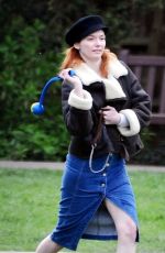 ELEANOR TOMLINSON with Her Dog at a Park in London 03/29/2019