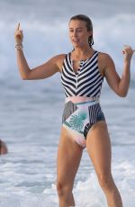 LIV PHYYLAND in Swimsuit Surfing at Bondi Beach in Sydney 03/08/2019