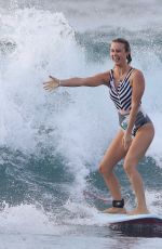 LIV PHYYLAND in Swimsuit Surfing at Bondi Beach in Sydney 03/08/2019