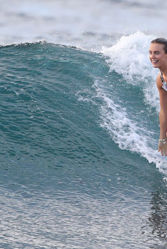 LIV PHYYLAND in Swimsuit Surfing at Bondi Beach in Sydney 03/08/2019