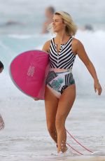 LIV PHYYLAND in Swimsuit Surfing at Bondi Beach in Sydney 03/08/2019
