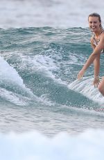 LIV PHYYLAND in Swimsuit Surfing at Bondi Beach in Sydney 03/08/2019