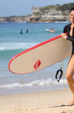 MADDY KING in Wetsuit Surfing at Bondi Beach 03/30/2019