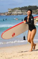 MADDY KING in Wetsuit Surfing at Bondi Beach 03/30/2019