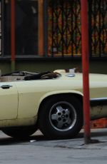 MARGOT RPBBIE in Yellow Jaguar on the Set of Birds of Prey in Los Angeles 03/28/2019