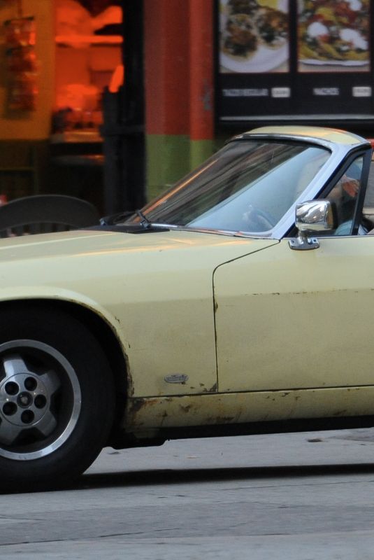MARGOT RPBBIE in Yellow Jaguar on the Set of Birds of Prey in Los Angeles 03/28/2019