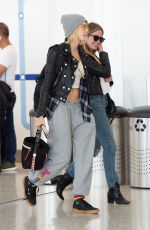 CARA DELEVINGNE and ASHLEY BENSON at JFK Airport in New York 05/08/2019