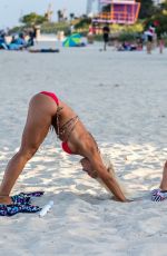 CLAUDIA ROMANI nad DAISY JAE in Bikinis Doing Yoga in South Beach 06/23/2019