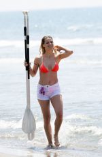 MICHELLE HUNZIKER in Bikini Paddlboarding in Forte Dei Marmi 06/17/2019