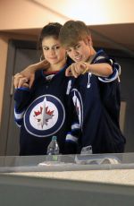 SELENA GOMEZ and Justin Bieber at a Hockey Game in Winnipeg 10/22/2011