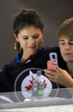 SELENA GOMEZ and Justin Bieber at a Hockey Game in Winnipeg 10/22/2011