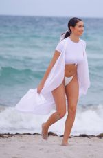 TAO WICKRATH in White Swimsuit on the Beach in Miami 07/24/2019