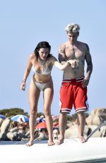 BELLA THORNE in Bikini and Beanjamin Mascolo at a Boat in Sardinia 08/21/2019