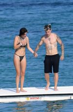BELLA THORNE in Black Bikini on Vacation in Sardinia 08/25/2019