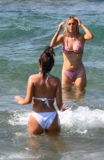 MEGAN BARTON HANSON and DEMI SIMS in Bikinis at Celebs Go Dating Show Set in Crete 07/31/2019