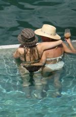 MILEY CYRUS and KAITLYNN CARTER in Bikinis at a Pool in Italy 08/11/2019