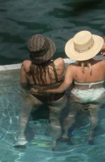 MILEY CYRUS and KAITLYNN CARTER in Bikinis at a Pool in Italy 08/11/2019