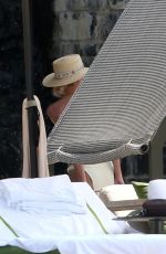 MILEY CYRUS and KAITLYNN CARTER in Bikinis at a Pool in Italy 08/11/2019