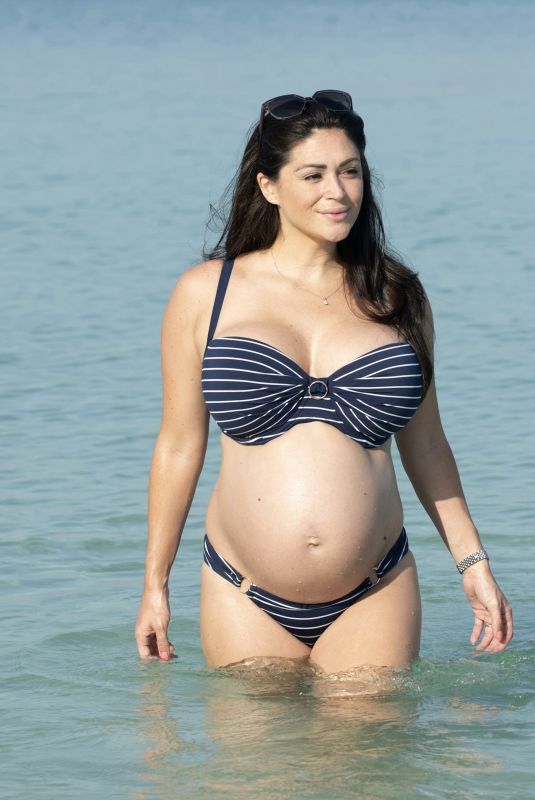 Pregnant CASEY BATCHELOR in Bikini on the Beach in Dubai 10/15/2019