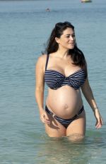 Pregnant CASEY BATCHELOR in Bikini on the Beach in Dubai 10/15/2019