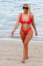 CHLOE FERRY in a Red Bikini on the Beach in Dubai 10/17/2019