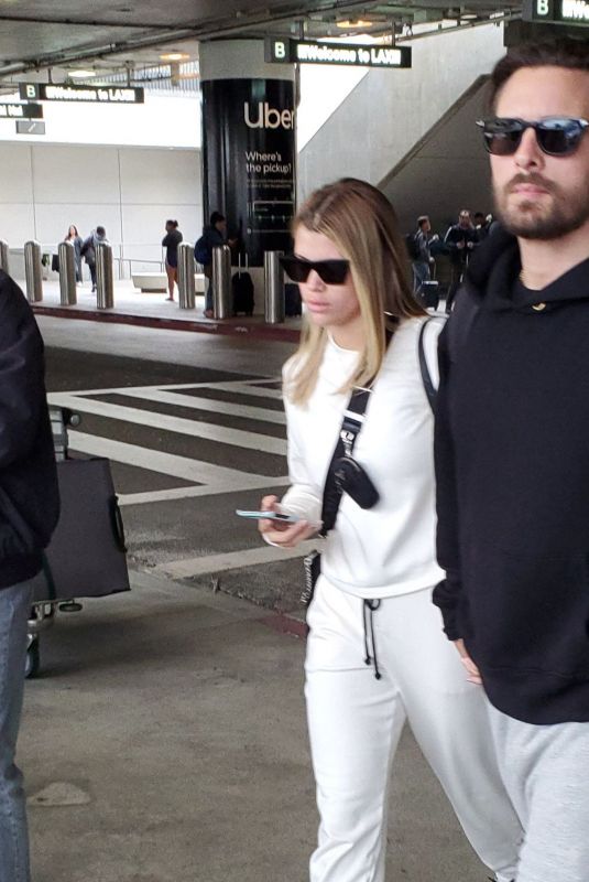 SOFIA RICHIE and Scott Disick at LAX Airport in Los Angeles 12/21/2019