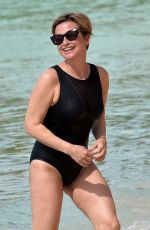 EMMA FORBES in a Black Swimsuit at a Beach in Barbados 01/01/2020