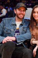LILY COLLINS and Charlie McDowell at Cleveland Cavaliers vs LA Lakers Game in Los Angeles 01/13/2020