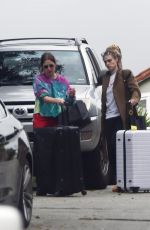 ASHLEY BENSON and CARA DELEVINGNE Out with Their Luggage in Los Angeles 03/16/2020