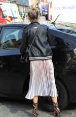 ASHLEY ROBERTS in Shimmering Skirt, Biker Jacket and Animal Printed Boots Out in London 03/17/2020