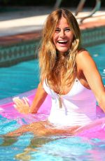 KELLY BENSIMON in Swimsuit at Her Pool in West Palm 03/19/2020