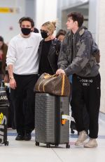 NICOLA PELTZ and Brooklyn Beckham Wear Matching Masks at JFK Airport in New York 03/09/2020