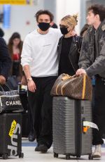 NICOLA PELTZ and Brooklyn Beckham Wear Matching Masks at JFK Airport in New York 03/09/2020