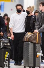 NICOLA PELTZ and Brooklyn Beckham Wear Matching Masks at JFK Airport in New York 03/09/2020