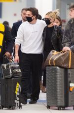 NICOLA PELTZ and Brooklyn Beckham Wear Matching Masks at JFK Airport in New York 03/09/2020