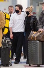 NICOLA PELTZ and Brooklyn Beckham Wear Matching Masks at JFK Airport in New York 03/09/2020