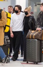 NICOLA PELTZ and Brooklyn Beckham Wear Matching Masks at JFK Airport in New York 03/09/2020