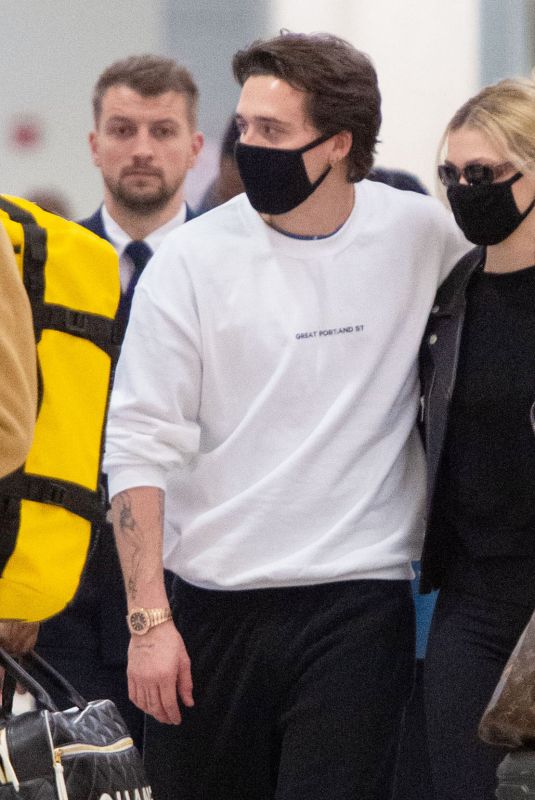 NICOLA PELTZ and Brooklyn Beckham Wear Matching Masks at JFK Airport in New York 03/09/2020